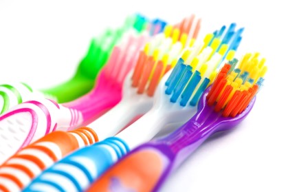 set of multicolored toothbrushes isolated on white